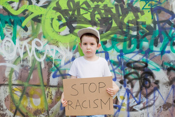 Boy with anti-racist carboard sign