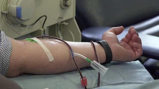 male caucasian donor hand donate PRP blood plasma, COVID-19 corona virus disease crisis, needle in vein detail