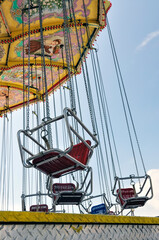 Empty big swings at a carnival express the concept of cancelled or closed fairgrounds during the pandemic.