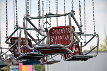 Fototapeta na wymiar Empty big swings at a carnival express the concept of cancelled or closed fairgrounds during the pandemic.