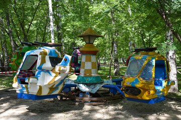 Old attraction, carousel with helicopters. Indoor park during a pandemic. An empty park without people with abandoned carousels. Closed fair with empty rides
