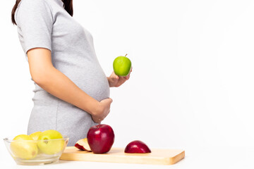 Health concept. Pregnant girl hold green apple or fruit for eating. It is healthy food for mother or pregnant woman. Mom care and concern her baby so much with copy space, isolated on white background