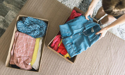 Woman preparing clothes for online clothing sale. The concept of zero pollution and eco-friendly...