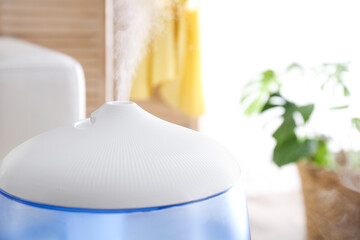 Modern air humidifier at home, closeup view. Space for text