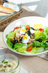 Chef's salad with tuna fish, black olives and egg in caper-mayonaisse sauce.