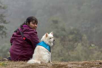 a female model sitting with a dog