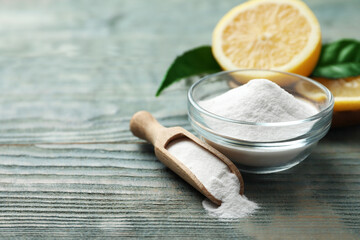 Baking soda and cut lemon on blue wooden table. Space for text