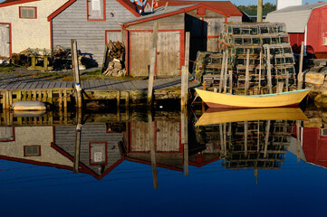 Fototapeta na wymiar Quiet yellow and brown boat at Fishermans Cove Eastern Passage Halifax Nova Scotia
