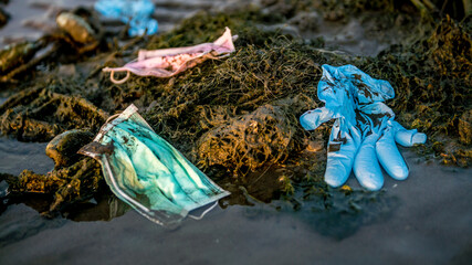 Waste during COVID-19. Environmental and coast pollution. Trash in beach