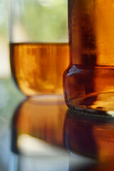 Close up of amber liquor in a bottle and glass 
