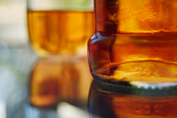 Close up of amber liquor in a bottle and glass 