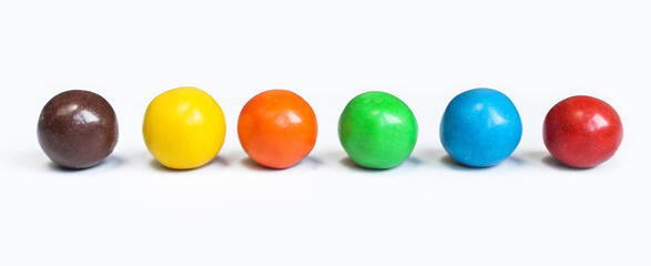 Chocolate covered balls isolated on white background. Colorful chocolate coated candies.