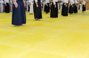 Obraz premium People in kimono on martial arts weapon training seminar