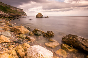 Rocky, rugged coastline at Llandudno, North Wales. Wet rocks and smooth sea at the beach