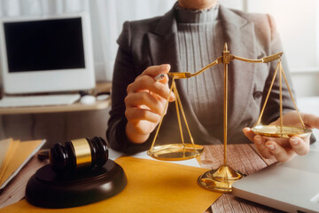 Business and lawyers discussing contract papers with brass scale on desk in office. Law, legal...