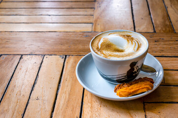 Cup of warm Espresso on the wooden table