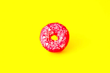 Colored donuts with colorful sprinkles on yellow background. Donut day concept. Close-up
