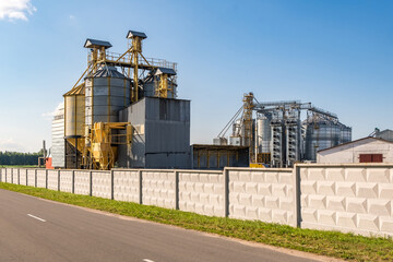 Obraz premium silver silos on agro-processing and manufacturing plant for processing drying cleaning and storage of agricultural products, flour, cereals and grain. Granary elevator.