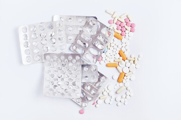 pills and capsules in blisters on of white background. composition on a medical theme. flat lay, top view
