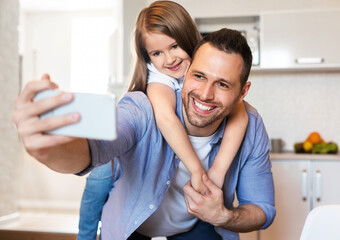 Cheerful Dad And Daughter Making Selfie Having Fun In Kitchen