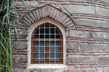 Historical old stone wall structure and window on it.