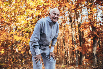 Senior Man Exercising In Park, having fun