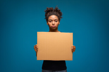 African american woman standing with blank protest banner