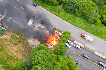 EBBW VALE, WALES, UK - JUNE 26 2020: Aerial view of firefighters tackling a small blaze in a...