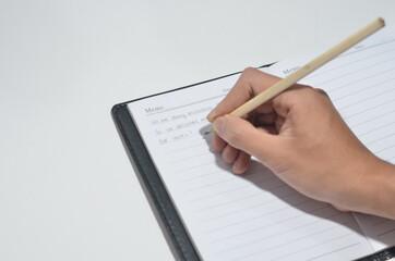 Hand Writing in The Notebook with Isolated White Background
