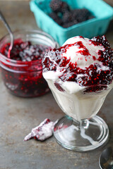 Vanilla ice cream sundae with raspberry sauce