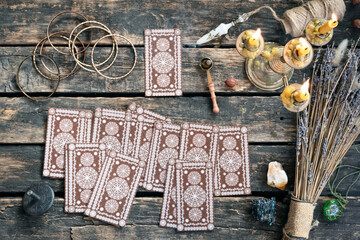 Tarot cards on the old wooden table background.