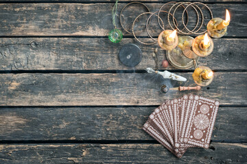 Tarot cards on the old wooden table background.