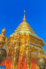 Fototapeta premium Beautiful northern Thai style architectural of golden pagoda and golden Buddha Image at Wat Phra That Doi Suthep, the famous temple and became the landmark of Chiang Mai, Thailand.