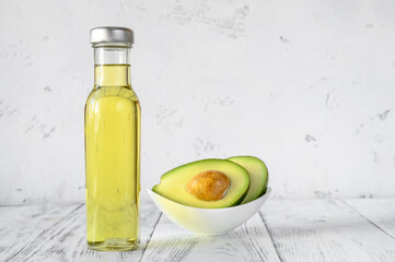 Bottle of avocado oil with fresh avocado