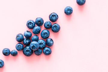 Colorful fruit pattern of blueberries on pink background. Top view. Flat lay