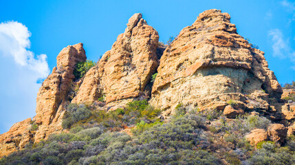 Fototapeta premium majestic jagged rock peaks on a hillside in the Santa Monica Mountains near Malibu, California on a sunny day