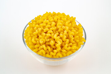 Raw pasta in a glass bowl close-up