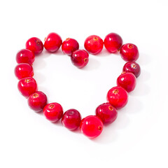Heart made of cranberries isolated on a white background.