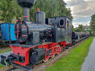 Old steam engine locomotives on narrow gauge tracks in the museum