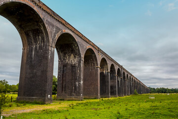 Fototapeta na wymiar A view towards the eastern end of the Harringworth railway viaduct, the longest masonry viaduct in the UK