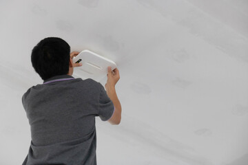 Technician installing wireless system for service user.