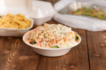 Chicken salad in plastic plate, delivery meal.
