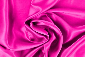 Purple fabric close up background.Luxury satin cloth textured backdrop.Smooth elegant purple silk or satin cloth texture.Wavy glossy silk drapery.