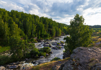 Fototapeta na wymiar Many rapids with waterfalls, spray foam and whirlpools close-up, rotate camera. Ural region, Russia. The threshold Revun.