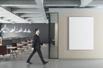 Businessman walking in modern office interior