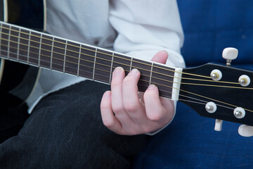 Fototapeta na wymiar Playing guitar. A man plays the guitar. Close up.