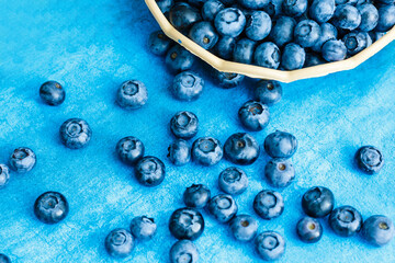 Blueberries on colorful blue background. Can be used for blueberry, blue, color, colorful, vitamin, nutrition, fruit, berries, antioxidant, summer, fun, food themes