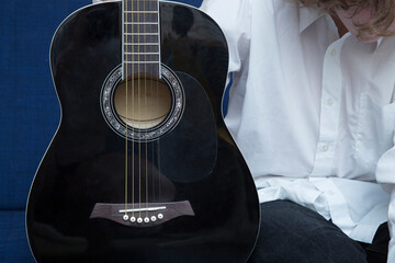 Fototapeta premium Playing guitar. A man plays the guitar. Close up.