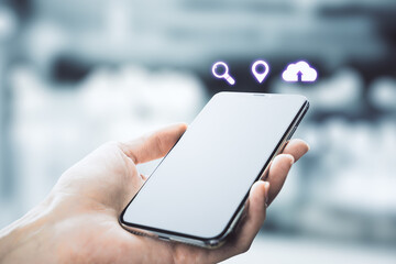 Hand holding phone with abstract digital icons