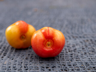 Cherry berries close-up on ttable on gray background. Sweet cherry with leaves. Plastic jar with fruits